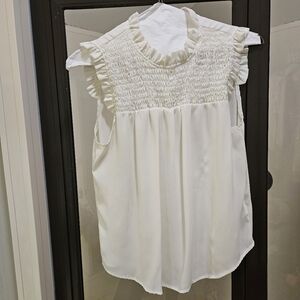 White sleeveless blouse.